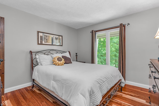 5052 Sherwood Ct, Pittsboro, IN 46167 - bedroom with wood finished floors and a textured ceiling