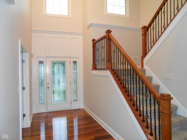 7653 W Old Colony Dr, New Palestine, IN 46163 - foyer entrance featuring a towering ceiling, wood finished floors, and stairway