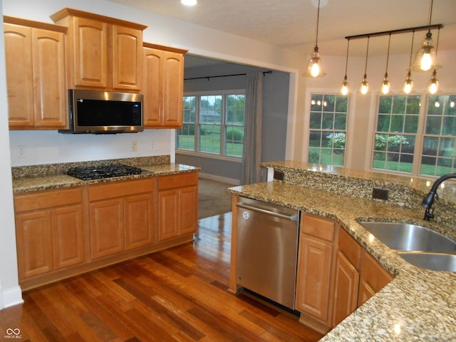 7653 W Old Colony Dr, New Palestine, IN 46163 - kitchen with appliances with stainless steel finishes, dark wood finished floors, light stone countertops, and pendant lighting