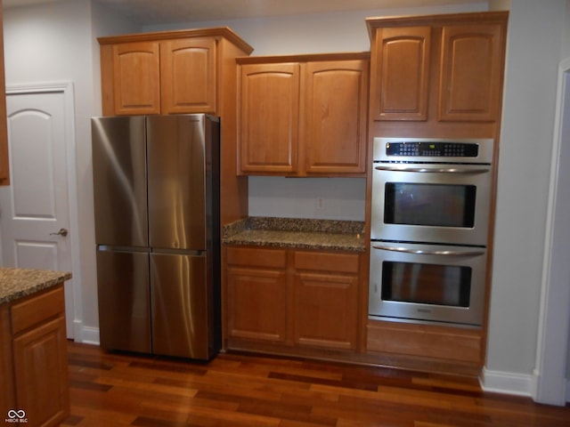 7653 W Old Colony Dr, New Palestine, IN 46163 - kitchen featuring stainless steel appliances, dark stone counters, and dark wood finished floors