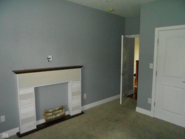 7653 W Old Colony Dr, New Palestine, IN 46163 - unfurnished living room with carpet flooring and baseboards