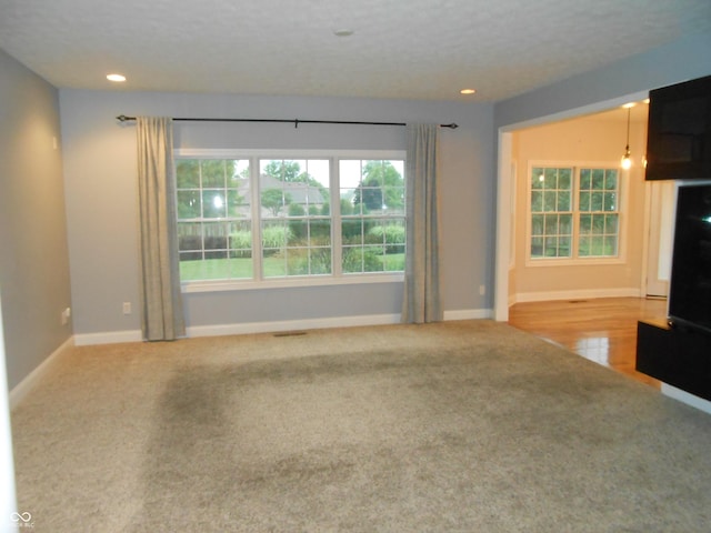 7653 W Old Colony Dr, New Palestine, IN 46163 - unfurnished living room featuring carpet flooring and recessed lighting