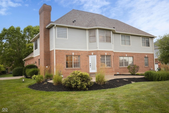 7653 W Old Colony Dr, New Palestine, IN 46163 - back of house featuring a chimney, brick siding, and a yard