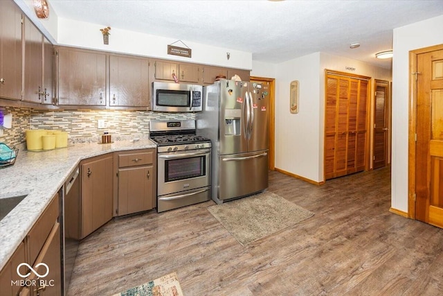 8546 N Chickadee Dr, Morgantown, IN 46160 - kitchen featuring appliances with stainless steel finishes, light wood-style floors, and decorative backsplash