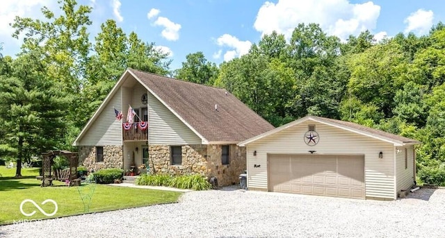 8546 N Chickadee Dr, Morgantown, IN 46160 - view of front of home featuring stone siding, a balcony, a front lawn, and a detached garage