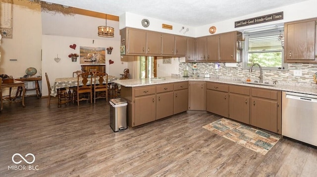 8546 N Chickadee Dr, Morgantown, IN 46160 - kitchen featuring stainless steel dishwasher, decorative backsplash, wood finished floors, and a peninsula