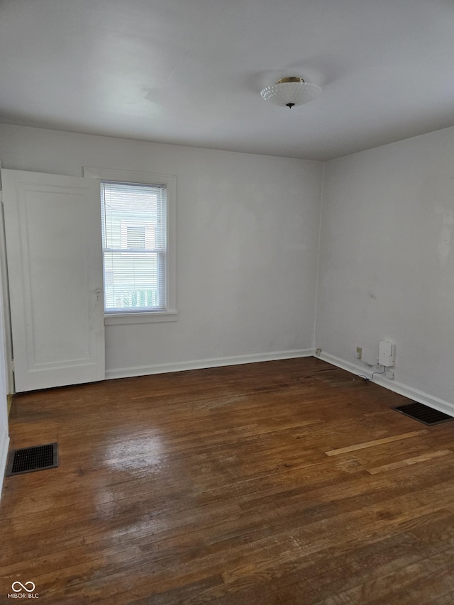 2311 Gilmore St, Columbus, IN 47201 - spare room with dark wood-style flooring and baseboards
