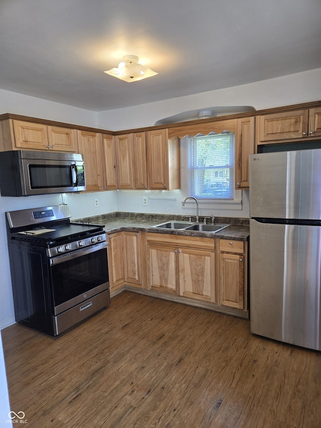 2311 Gilmore St, Columbus, IN 47201 - kitchen with appliances with stainless steel finishes, dark countertops, and dark wood-style flooring