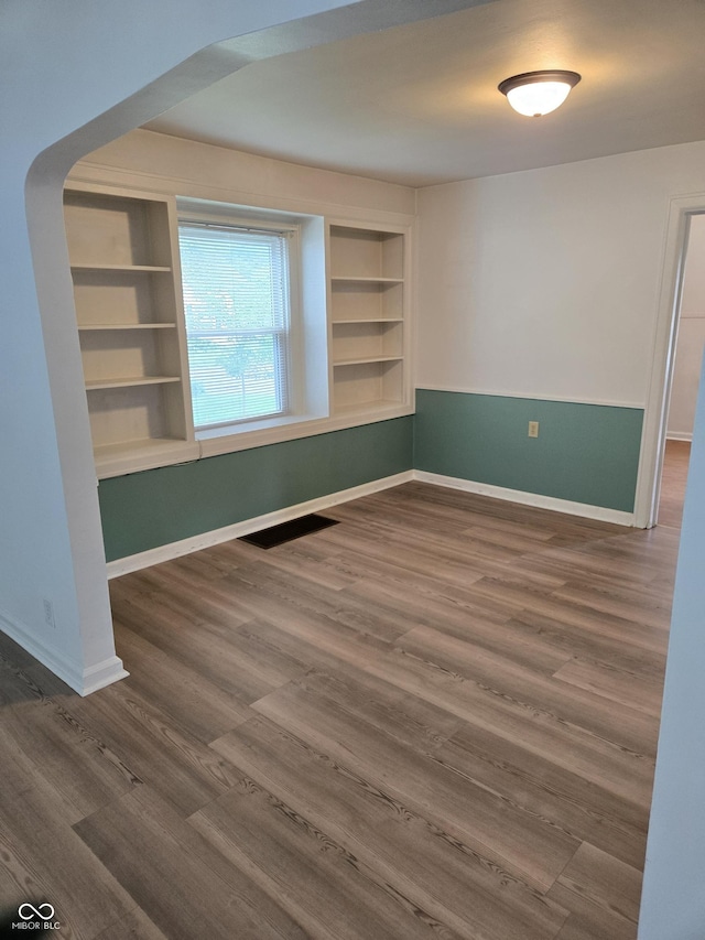 2311 Gilmore St, Columbus, IN 47201 - empty room with dark wood finished floors and built in shelves