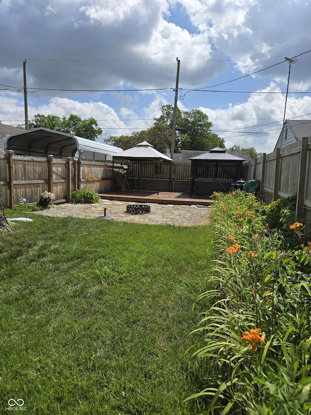 2311 Gilmore St, Columbus, IN 47201 - fenced backyard with a deck, a gazebo, and a detached carport