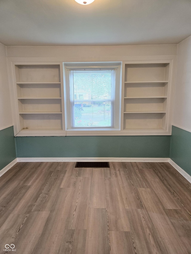 2311 Gilmore St, Columbus, IN 47201 - spare room with built in shelves and wood finished floors