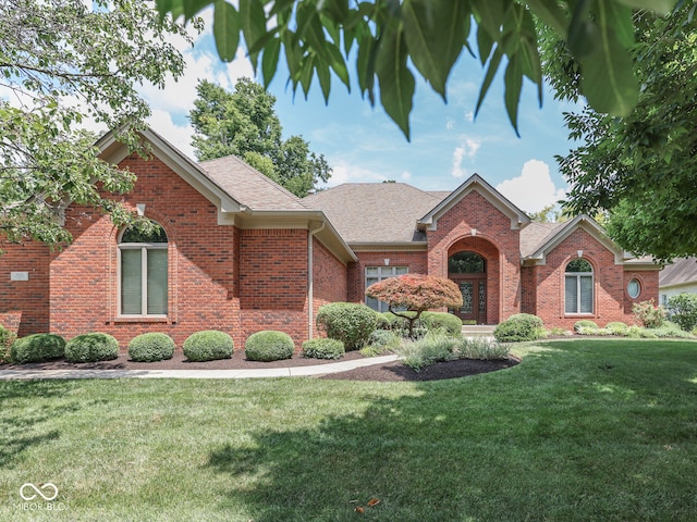 2025 Caledonian Ct, Greenwood, IN 46143 - view of front facade featuring a front lawn, brick siding, and a shingled roof