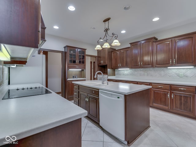 2025 Caledonian Ct, Greenwood, IN 46143 - kitchen featuring light countertops, white appliances, an island with sink, tasteful backsplash, and light tile patterned flooring