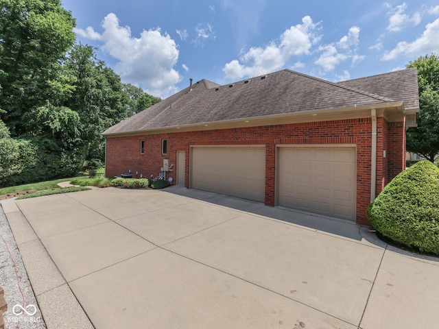 2025 Caledonian Ct, Greenwood, IN 46143 - view of home's exterior with brick siding, concrete driveway, a garage, and a shingled roof