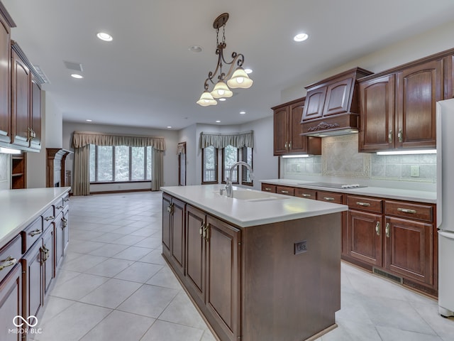 2025 Caledonian Ct, Greenwood, IN 46143 - kitchen featuring light countertops, backsplash, hanging light fixtures, recessed lighting, and an island with sink