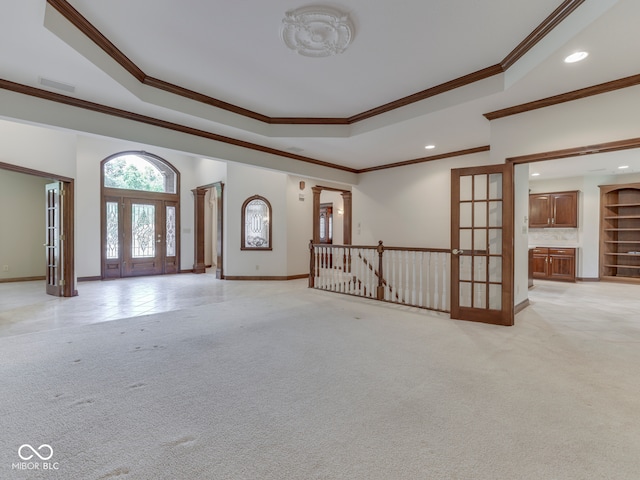 2025 Caledonian Ct, Greenwood, IN 46143 - unfurnished living room featuring ornamental molding, a raised ceiling, recessed lighting, and light colored carpet