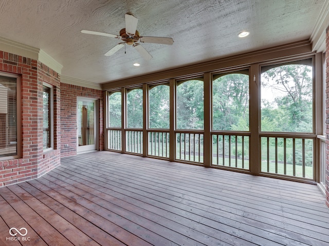 2025 Caledonian Ct, Greenwood, IN 46143 - unfurnished sunroom with ornamental molding, a textured ceiling, wood-type flooring, brick wall, and a wooden deck