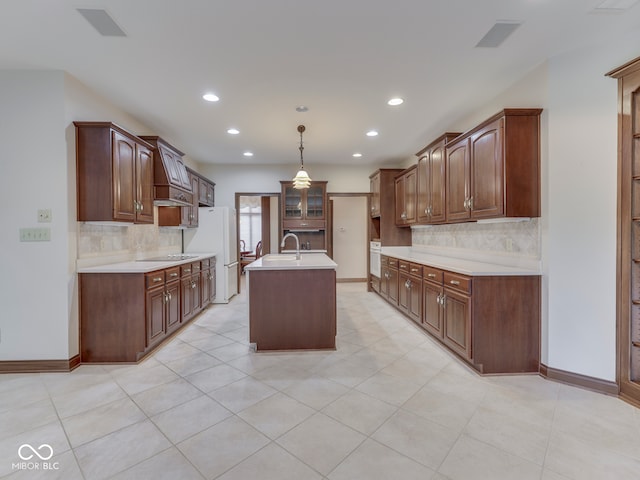 2025 Caledonian Ct, Greenwood, IN 46143 - kitchen featuring light countertops, tasteful backsplash, a center island with sink, recessed lighting, and white appliances