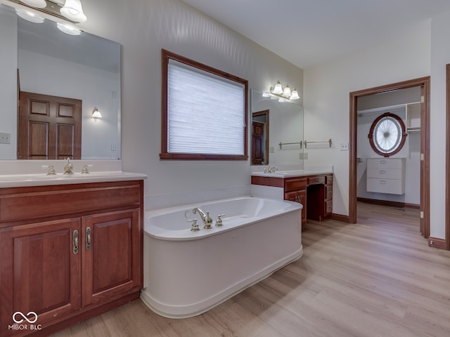 2025 Caledonian Ct, Greenwood, IN 46143 - full bathroom featuring wood finished floors, two vanities, and a bath