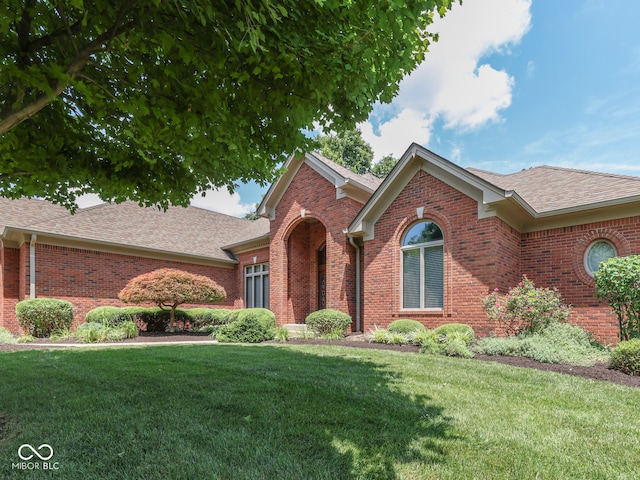 2025 Caledonian Ct, Greenwood, IN 46143 - ranch-style home featuring roof with shingles, a front yard, and brick siding