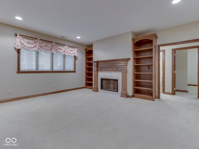 2025 Caledonian Ct, Greenwood, IN 46143 - unfurnished living room featuring a tiled fireplace, light carpet, and recessed lighting