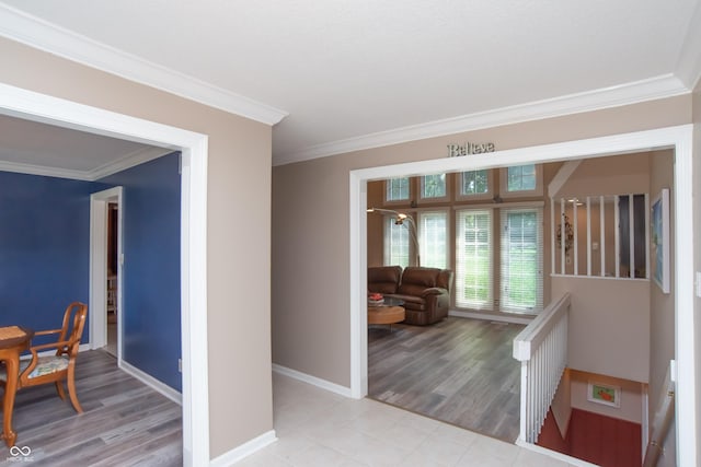 8841 Rocky Ridge Rd, Indianapolis, IN 46217 - hallway featuring crown molding, light wood-style floors, and an upstairs landing
