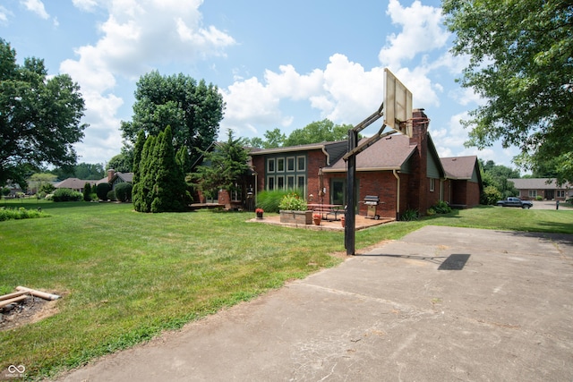 8841 Rocky Ridge Rd, Indianapolis, IN 46217 - view of front of house with a front lawn, brick siding, and a chimney