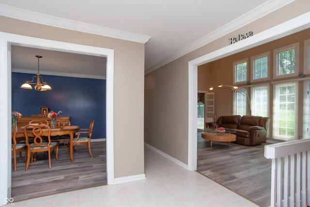 8841 Rocky Ridge Rd, Indianapolis, IN 46217 - dining room with crown molding, a chandelier, and light wood-style floors