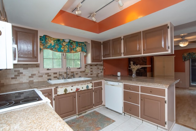 8841 Rocky Ridge Rd, Indianapolis, IN 46217 - kitchen featuring dishwasher, light countertops, a ceiling fan, a peninsula, and decorative backsplash