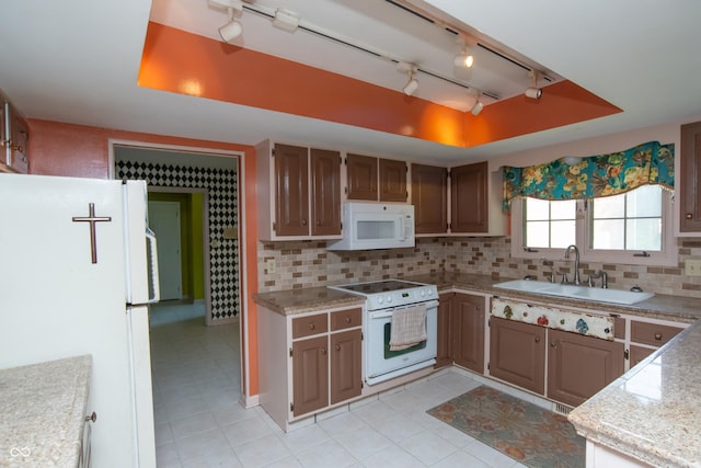 8841 Rocky Ridge Rd, Indianapolis, IN 46217 - kitchen featuring white appliances, track lighting, light countertops, tasteful backsplash, and a raised ceiling