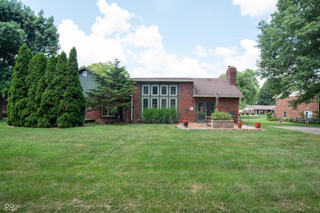 8841 Rocky Ridge Rd, Indianapolis, IN 46217 - view of front of property with brick siding, a front lawn, a chimney, and a patio