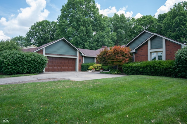 8841 Rocky Ridge Rd, Indianapolis, IN 46217 - view of front facade featuring brick siding, a front lawn, a garage, and concrete driveway