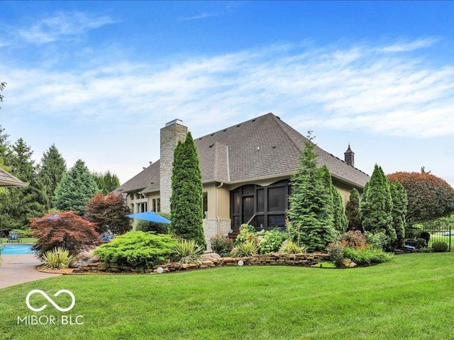 3808 Claybrook Ct, Bargersville, IN 46106 - view of side of home featuring a lawn, a chimney, a shingled roof, and an outdoor pool