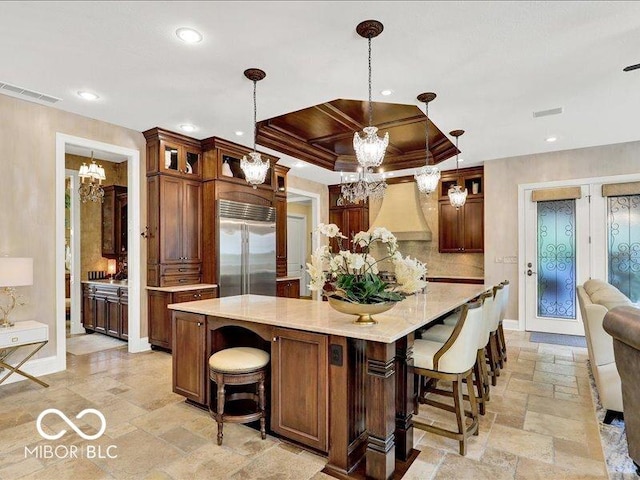 3808 Claybrook Ct, Bargersville, IN 46106 - kitchen with built in fridge, a chandelier, stone tile flooring, recessed lighting, and light countertops