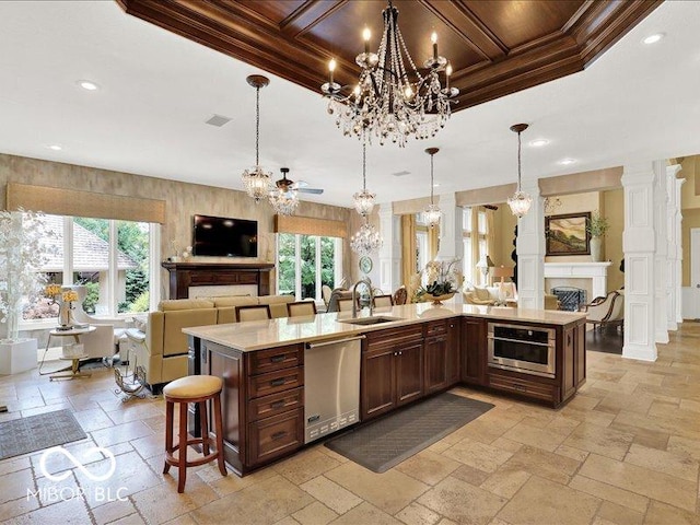 3808 Claybrook Ct, Bargersville, IN 46106 - kitchen featuring open floor plan, a chandelier, stainless steel dishwasher, stone tile floors, and light countertops