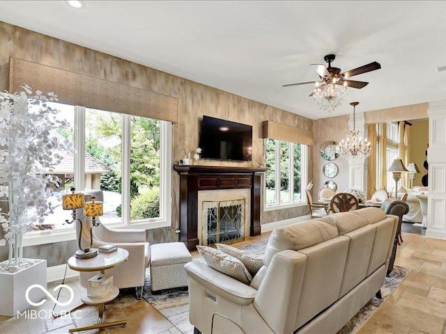 3808 Claybrook Ct, Bargersville, IN 46106 - living area with a ceiling fan, a premium fireplace, stone tile floors, and a chandelier