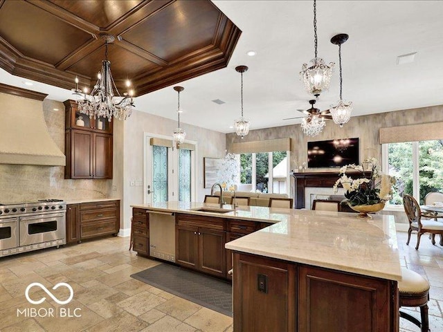 3808 Claybrook Ct, Bargersville, IN 46106 - kitchen with a chandelier, stainless steel appliances, custom range hood, backsplash, and stone tile flooring