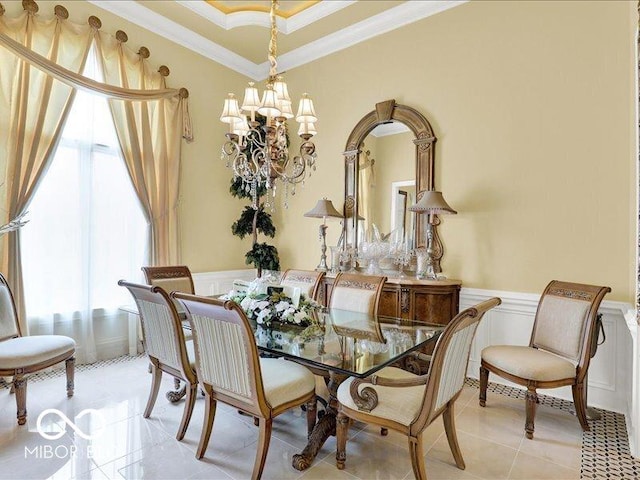 3808 Claybrook Ct, Bargersville, IN 46106 - dining space featuring crown molding, a decorative wall, a chandelier, wainscoting, and light tile patterned floors