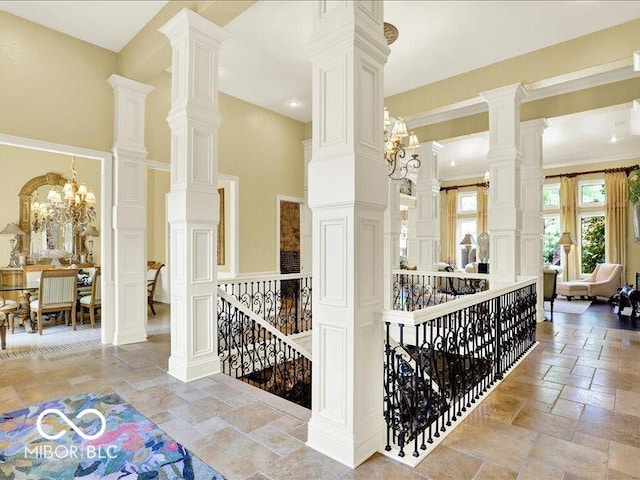 3808 Claybrook Ct, Bargersville, IN 46106 - corridor featuring stone tile flooring, an upstairs landing, a high ceiling, a decorative wall, and a chandelier