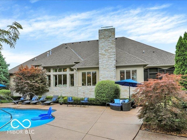 3808 Claybrook Ct, Bargersville, IN 46106 - back of house featuring a patio area, a shingled roof, a chimney, an outdoor pool, and stone siding