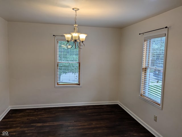 1630 Lawton Ave, Columbus, IN 47201 - empty room with dark wood-style floors and a chandelier