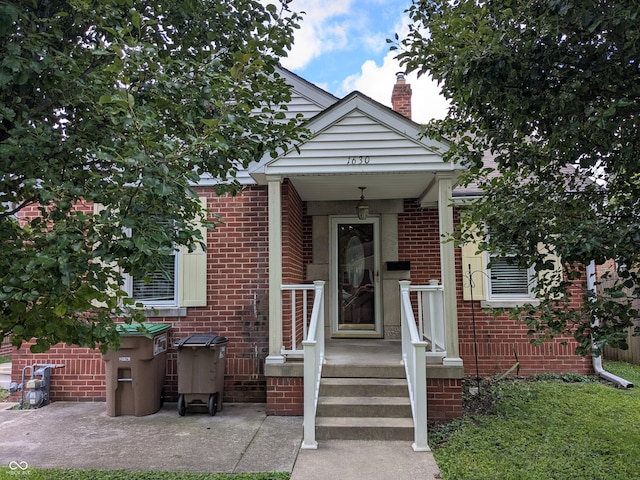 1630 Lawton Ave, Columbus, IN 47201 - view of front of house with brick siding and a chimney