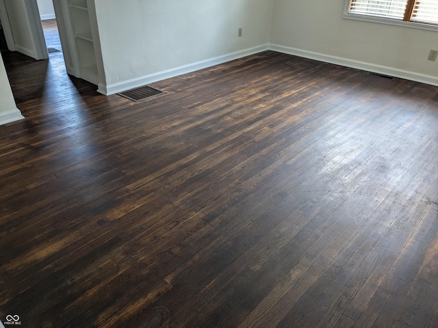 1630 Lawton Ave, Columbus, IN 47201 - spare room with baseboards and dark wood-style floors