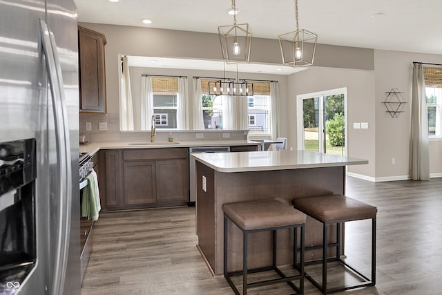 1715 Beyers St, Fortville, IN 46040 - kitchen with appliances with stainless steel finishes, plenty of natural light, a breakfast bar, light countertops, and recessed lighting