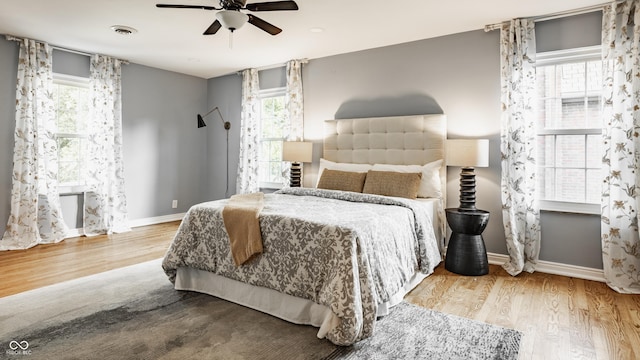 5809 N Washington Blvd, Indianapolis, IN 46220 - bedroom featuring wood finished floors, multiple windows, and ceiling fan