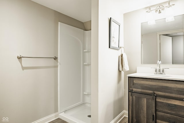 5809 N Washington Blvd, Indianapolis, IN 46220 - full bathroom with vanity, a stall shower, and wood finished floors