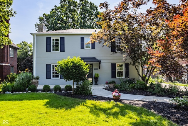 5809 N Washington Blvd, Indianapolis, IN 46220 - view of front of home with a chimney, a front yard, and brick siding