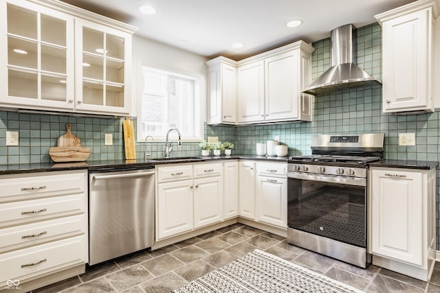 5809 N Washington Blvd, Indianapolis, IN 46220 - kitchen featuring stainless steel appliances, wall chimney exhaust hood, white cabinetry, glass insert cabinets, and tasteful backsplash