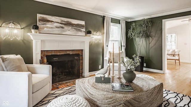 5809 N Washington Blvd, Indianapolis, IN 46220 - living room with healthy amount of natural light, ornamental molding, a fireplace, and light wood-type flooring