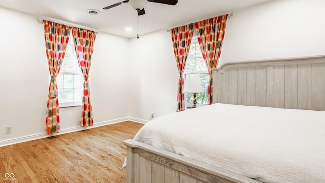 5809 N Washington Blvd, Indianapolis, IN 46220 - bedroom featuring multiple windows, wood finished floors, and ceiling fan